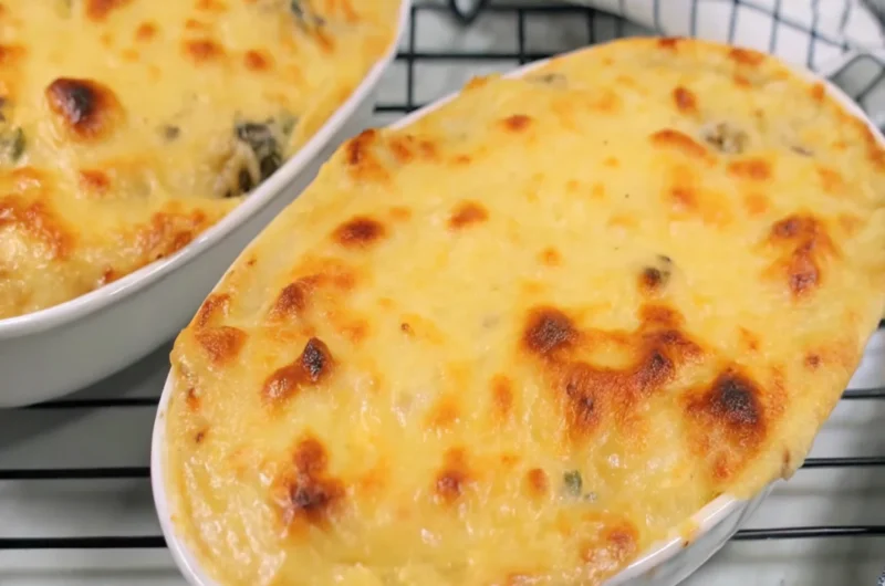 Delicious seafood casserole with shrimp, scallops, and crab topped with breadcrumbs and melted cheese.
