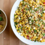 Elote corn salad with grilled corn kernels, cotija cheese, cilantro and lime - easy summer Mexican recipe served in white bowls