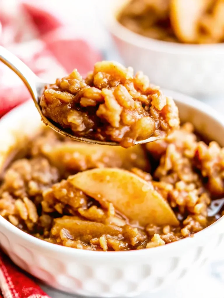 Close-up of a homemade peach crisp with tender peach slices and a golden oat topping in a bowl