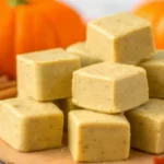 Delicious pumpkin fudge squares with cinnamon and fall decorations.
