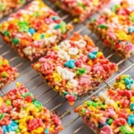 Fruity Pebbles rice crispy treats with gooey marshmallow and colorful cereal pieces.