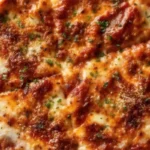 Easy lazy lasagna recipe with layers of cheese ravioli, meat sauce, and melted mozzarella cheese in a baking dish, ready to serve for a quick family dinner