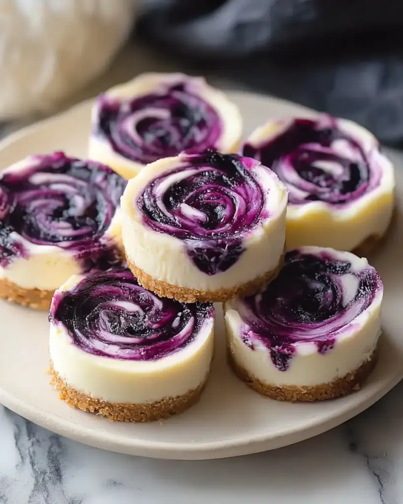 A delicious plate of Juicy Mini Lemon Blueberry Cheesecakes