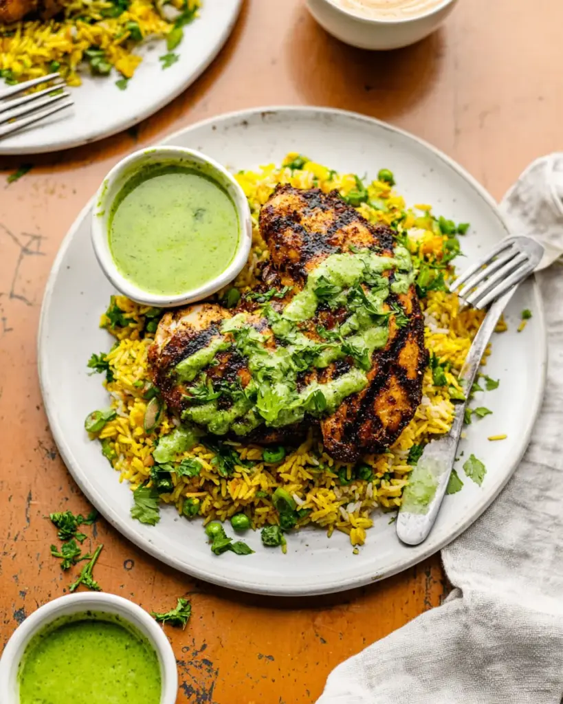 A delicious plate of Peruvian Chicken and Rice with Green Sauce
