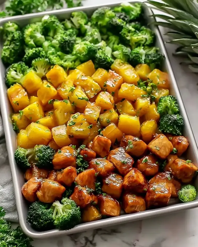 A delicious plate of Sweet Sheet Pan Pineapple Chicken and Broccoli - thegirlskitchen