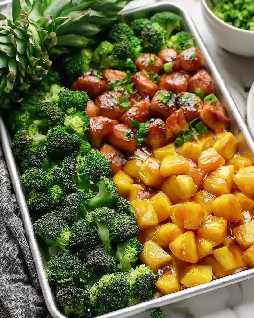 A delicious plate of Sweet Sheet Pan Pineapple Chicken and Broccoli - thegirlskitchen
